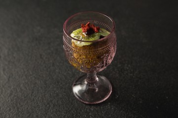 Dried fruits and granola bar in glass
