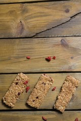 Three granola bars arranged on wooden table