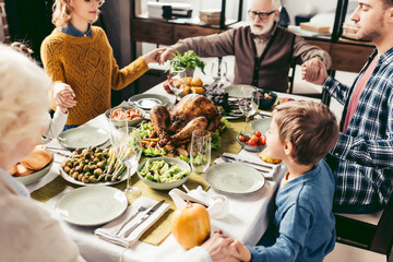 family holding hands and praying on thanksgiving