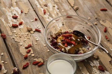 Breakfast cereals and milk on wooden table