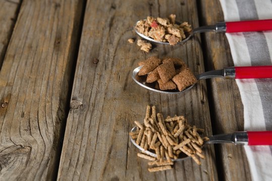 Three spoons with various breakfast cereals - Powered by Adobe