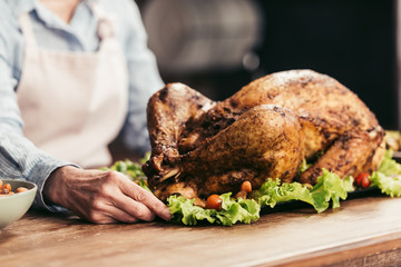 woman holding tray with turkey