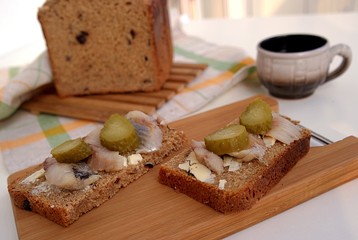 Tasty sandwiches with herring and pickled cucumber