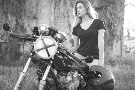 Attractive girl motorcycle rider posing