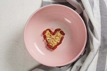 Dried fruits forming heart shape in plate
