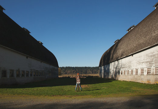 Girl checking out an old barn