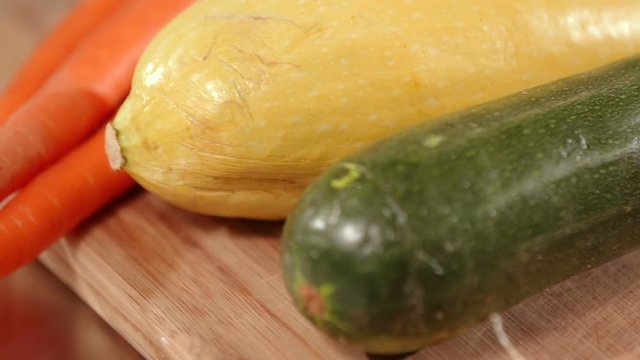 Carrots Squash and Zucchini Close Up. cooking ingredients on a cutting board close up of carrots, yellow squash and zucchini
