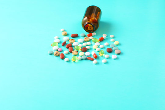 Medical pills and a bottle lie on the table. Medical concept