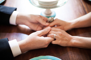 Couple holding hands across a table