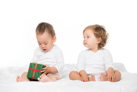 multiethnic toddlers with wrapped gift