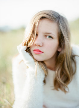 Relaxed portrait of a teen girl with pink lips and green eyes