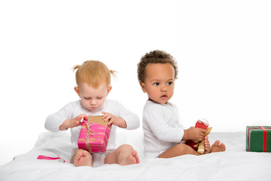multiethnic toddlers with wrapped gifts