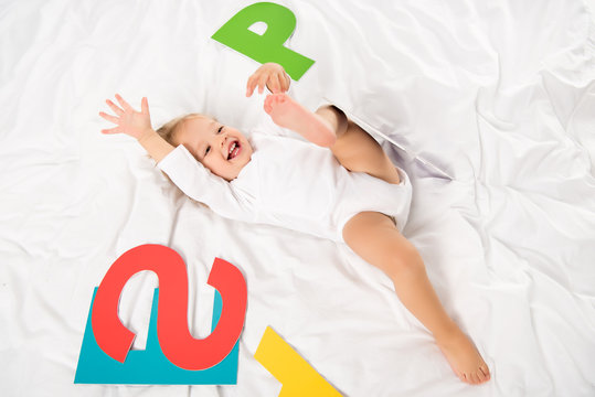 happy baby with paper letters