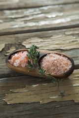 Himalayan salt with rosemary in wooden bowl
