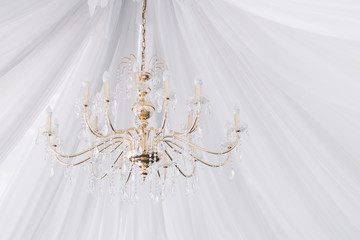 Chrystal chandelier close-up. Glamour tissue white background with copy space
