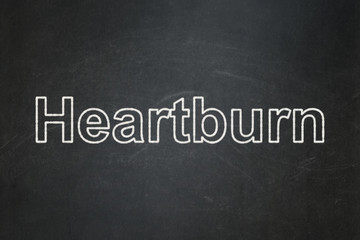 Medicine concept: Heartburn on chalkboard background