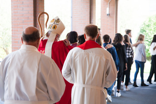 Vescovo che si avvia verso la chiesa con i suoi fedeli per la cresima