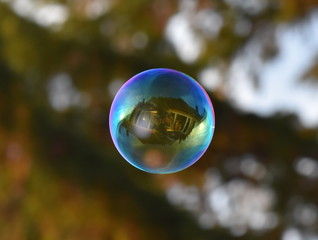 The reflection of a house in a soap bubble