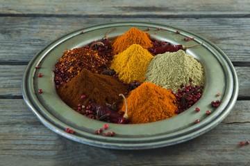 Various type of spices in plate on wooden table
