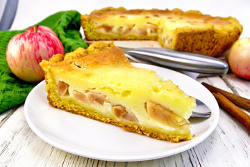 Pie apple with sour cream in plate on board