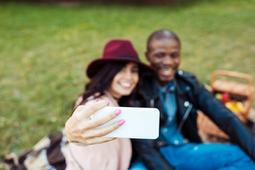 multicultural couple taking selfie