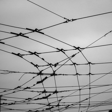 Electric wires for powering trolleys under cloudy sky