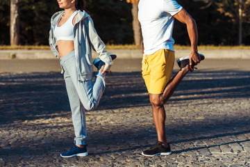Obraz premium couple stretching in park