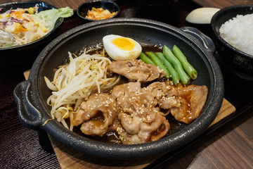 pork teppanyaki with egg and vegetables in hot plate Japanese Cooking