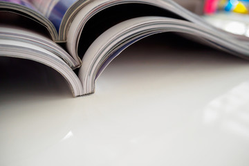 pile of magazines stack on white table in living room