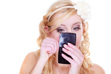 Woman checking makeup looking in mirror