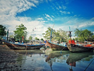 Fishing boats in the harbour with blue sky. Beautiful landscape and seascape of the traditional fisherman and nature.