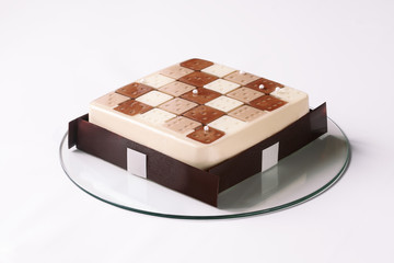 Contemporary Three Chocolates Mousse Cake on white background.