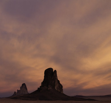 predawn colors and clouds above Kayenta and Agathla peaks in Monument Valley arizona