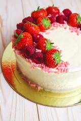 Christmas cake with berries on wooden background