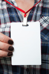 Identification of a blank white plastic card ID on the neck on the shirt in the square. Mockup for...