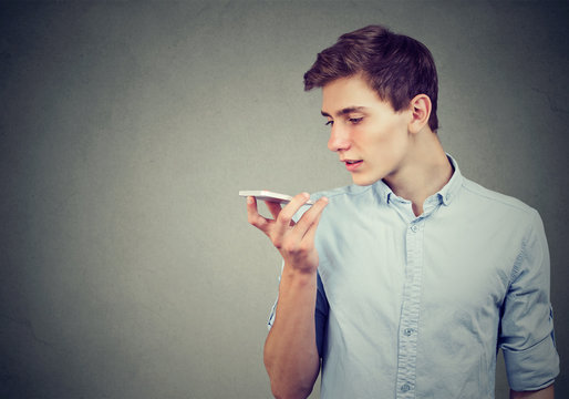 Young man using a smart phone voice recognition function