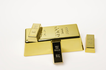 small and big gold bars isolated on white