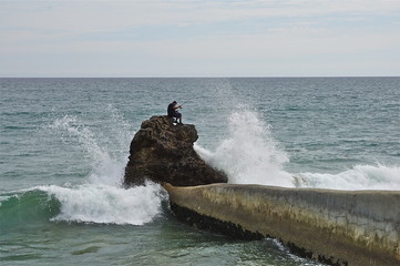 fisherman on a rock - 177437441