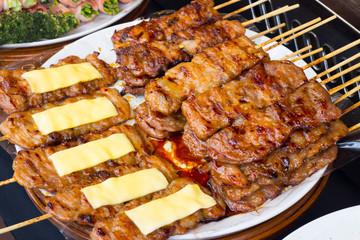 pork on the grill with flame. / Street food in Thailand. / thai style bbq grilled pork./ Grilled pork skewers at night market.