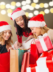 women with shopping bags and christmas gifts