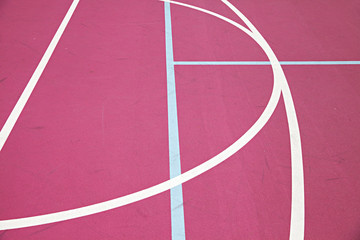 graphic colourful lines on a pink basketball court