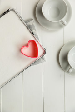 Pink heart shaped cookie cutter on white marshmallow