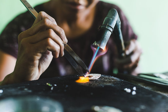 Woman making silver jewelry