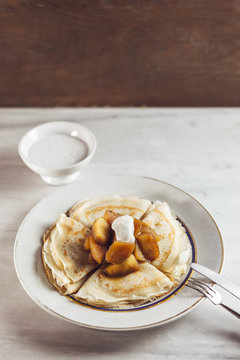 Thin pancakes with apples and cream