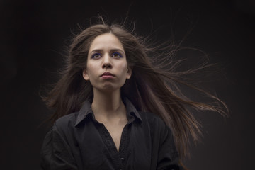 Fototapeta premium Girl with long hair on a black background