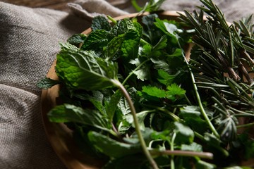 Fresh herbs in wooden plate © wavebreak3