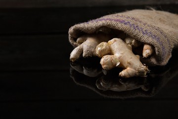 Ginger in sack on black background