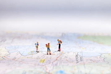  Miniature Group traveler with backpack standing on wold map for travel around the world.  Travel Concept, select focus.