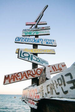 Signpost with directions and distance to different countries and cities of the world. Travel concept