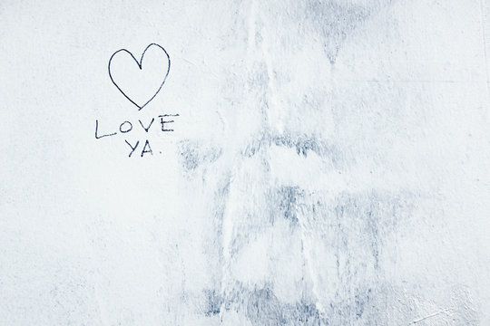 LOVE YA painted on exterior of building wall